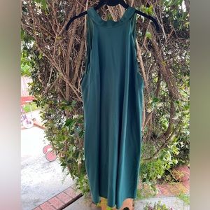 Green dress with scalloped sleeves and a bow tie back